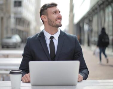 Man in suit with computer working at outdoor table livingonthepatio.com