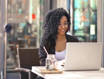 Woman with computer at outdoor cafe livingonthepatio.com