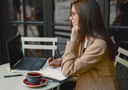 Woman working at outdoor bistro table livingonthepatio.com